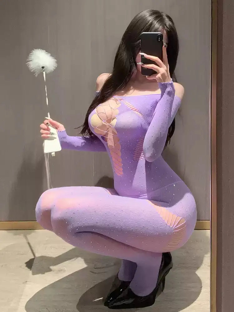 Model in purple sheer bodystocking squatting while holding feather prop, showcasing side cutouts and shimmer.