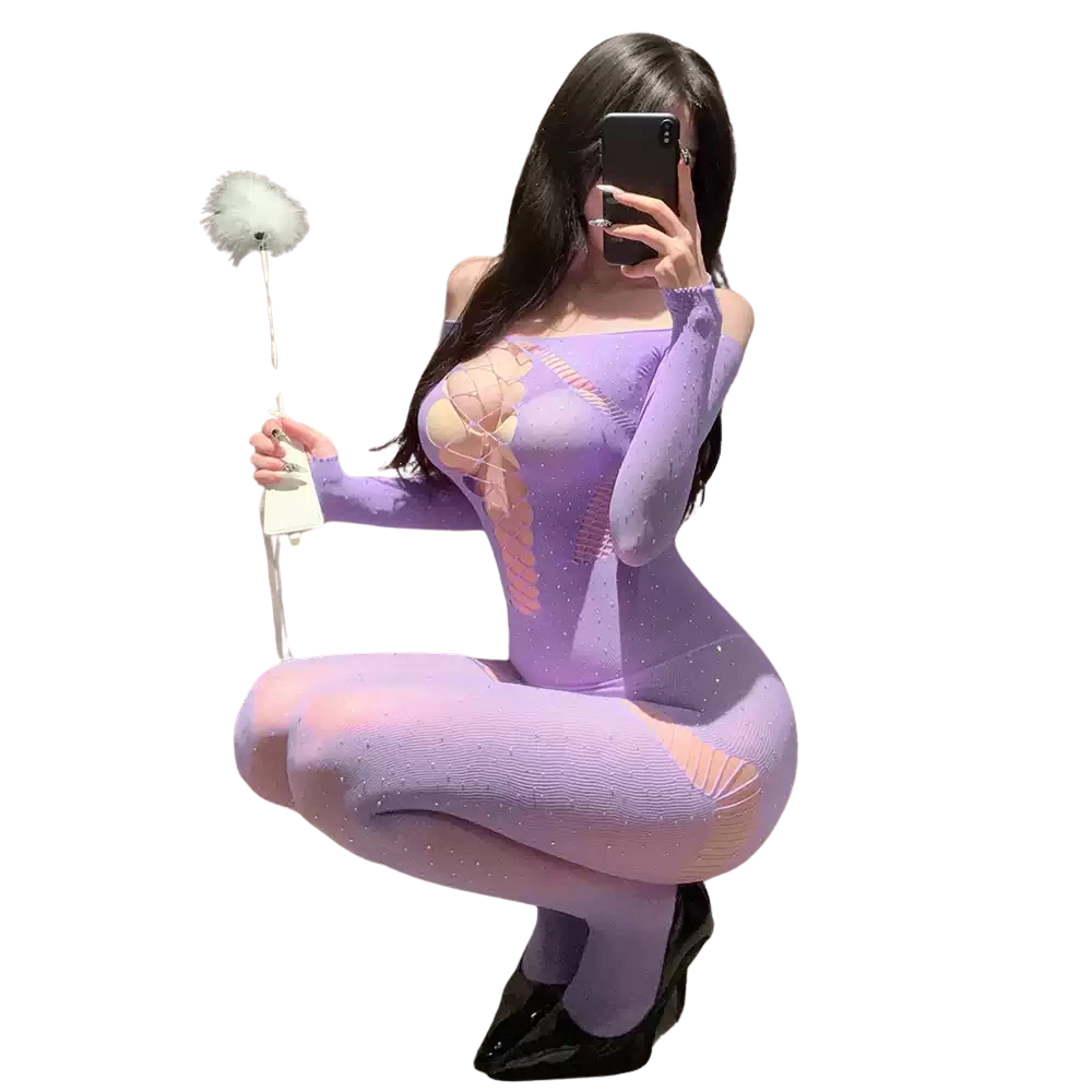 Model wearing a sexy lavender bodystocking lingerie with lace-up front and glitter details, holding a feather duster.