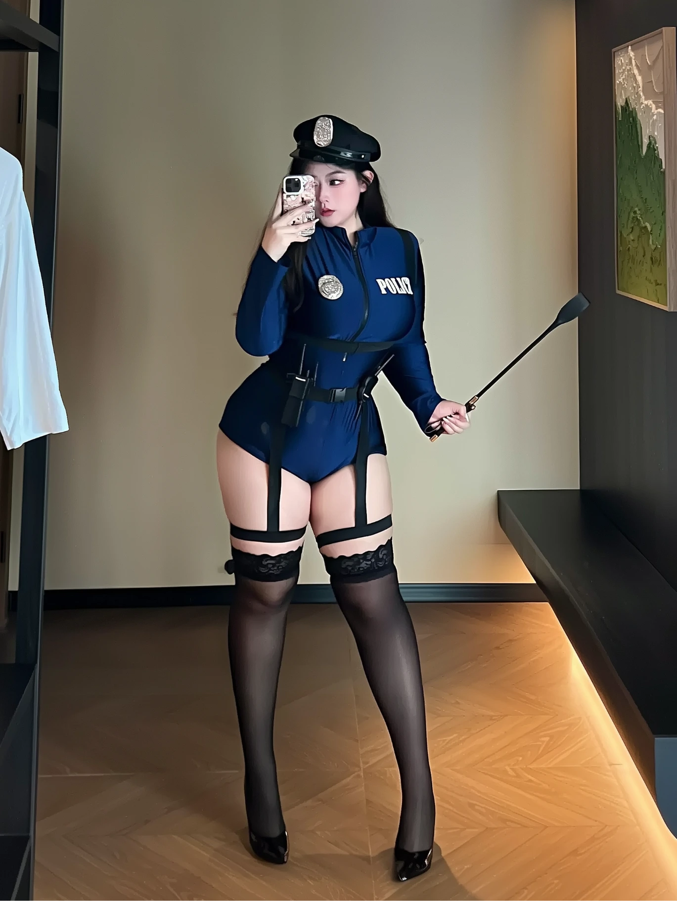 Seductive plus size cop costume with thigh-high stockings and garter straps, standing full body shot
